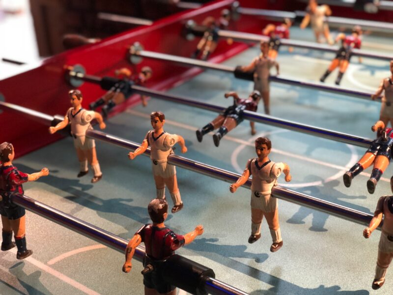 A close-up picture of the figures of men in a table football game